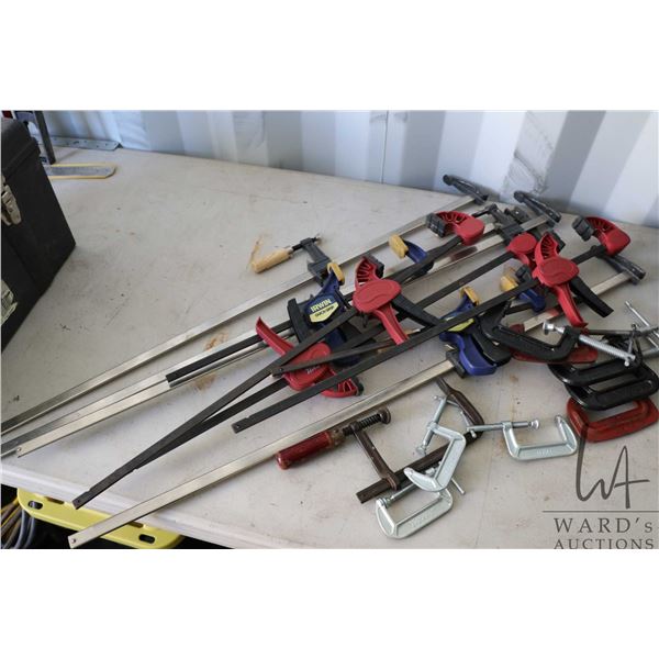 An assortment clamps including C-clamps, Irwin Quik Grip, Skill squeeze clamps etc.