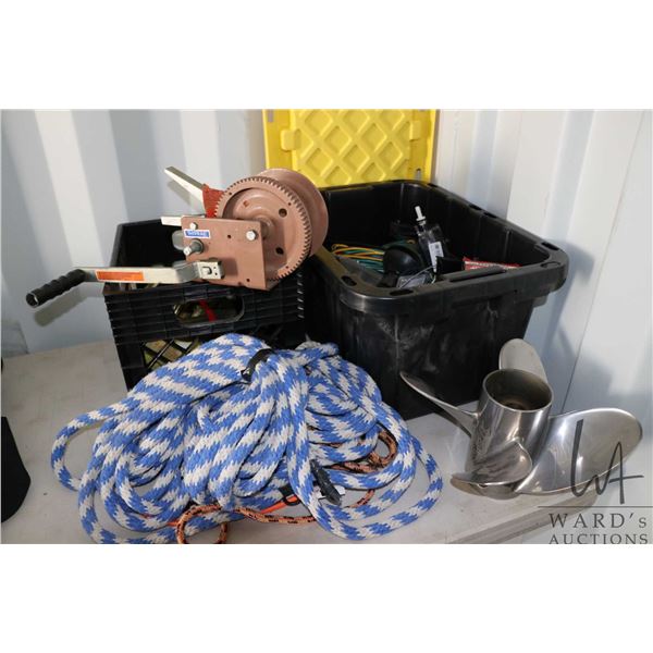 A black and yellow storage tote filled with boat and trailer repair supplies and a milk crate with a