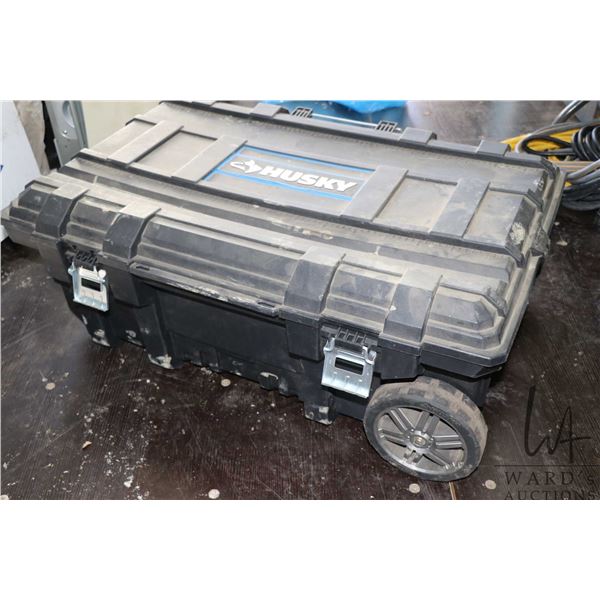 Large Huskey branded tool case with latching lid, wheels and extending handle