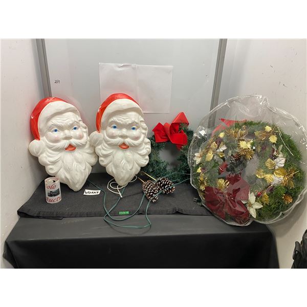Lot of outdoor Christmas items including wreaths and lighted Santa faces