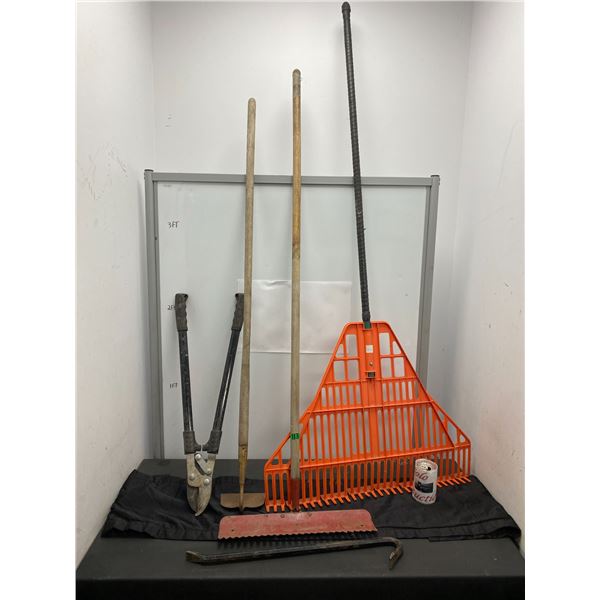 Lot of gardening tools including loppers, rakes and more