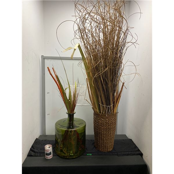 Home décor items including large glass vase and basket with decorative grasses