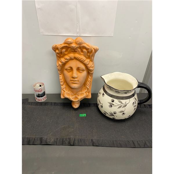 Ceramic pitcher and cement wall ornament