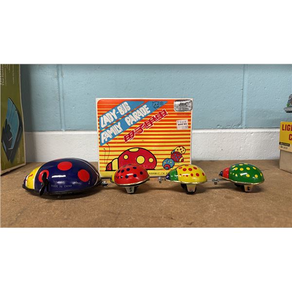 VINTAGE TIN LADY-BUG FAMILY PARADE TOY