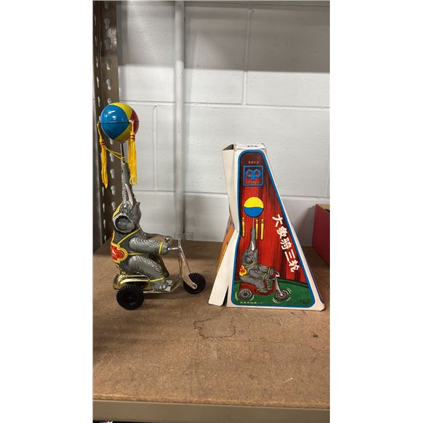 VINTAGE WIND UP TIN ELEPHANT ON BIKE TOY