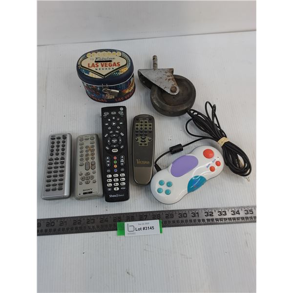 (4) TV Remotes, Las Vegas Coin Bank, Grocery Cart Wheel, Video Game Controller