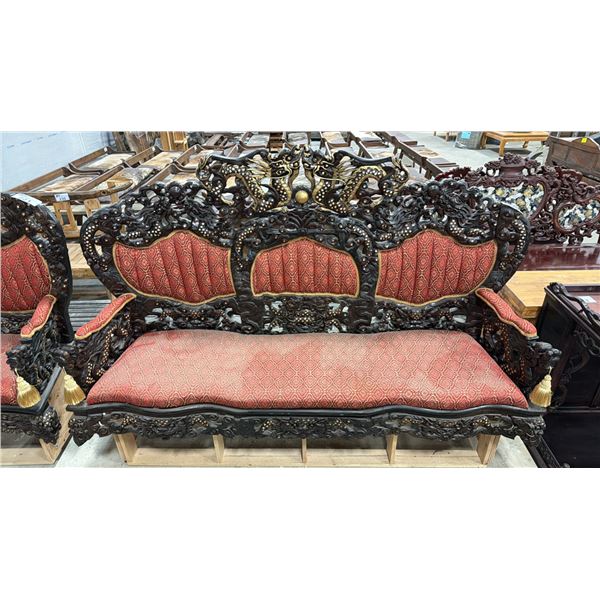 HEAVILY CARVED UPHOLSTERED ASIAN COUCH WITH DRAGON MOTIF ON PLYWOOD BASE