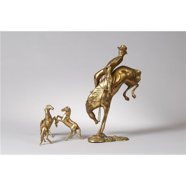 Two Vintage Brass Western Statuettes: A Bronco Rider and Three Horses Cradling a Crystal Ball