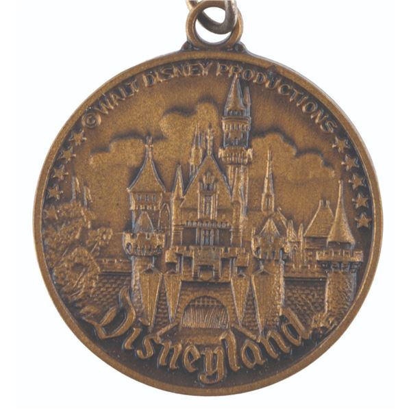 A 1960s Disneyland Lands Coin Keychain.