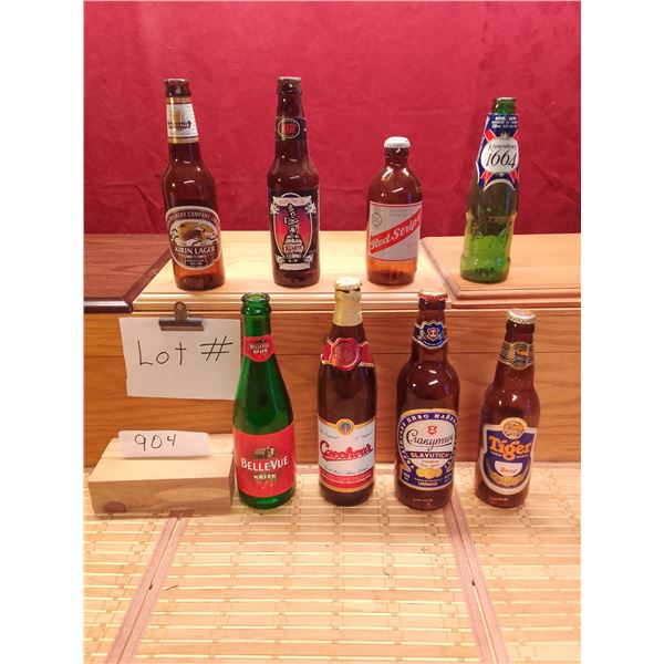 Lot # 904 Beer bottle collection features eight empty beer bottles, showcasing a variety of internat