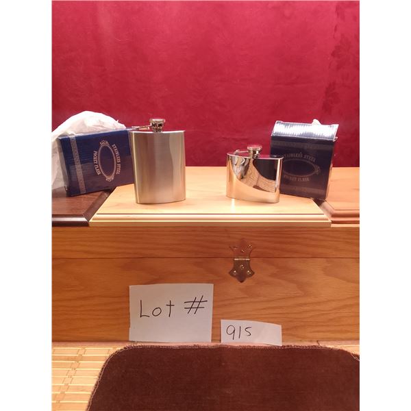 Lot # 915 Two elegant stainless steel pocket flasks are offered for auction: a classic rectangular m