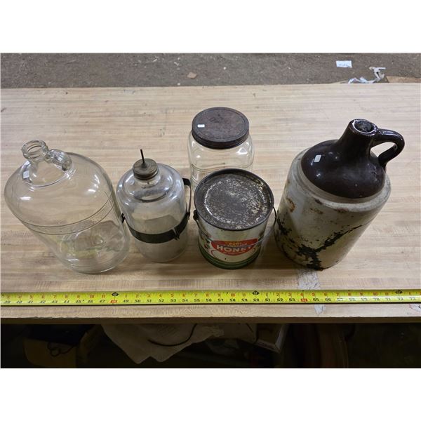 Lot of glass jugs, honey tin and whiskey jug