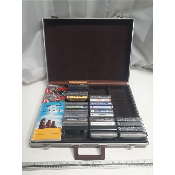 Collection of assorted audio cassette tapes in a carrying case.