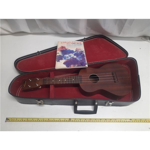 Vintage Favilla mahogany soprano ukulele with its case and a chord book.