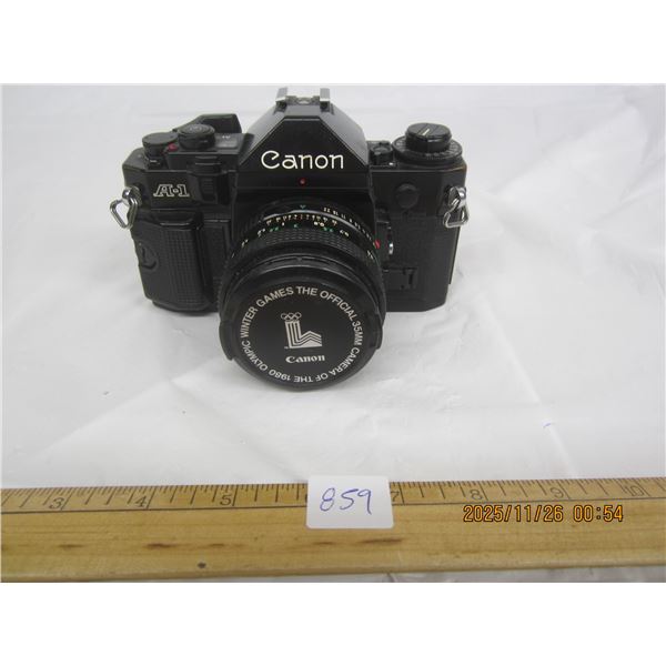 859. Black Canon A1 - 35 MM Camera with Lens in Good Shape