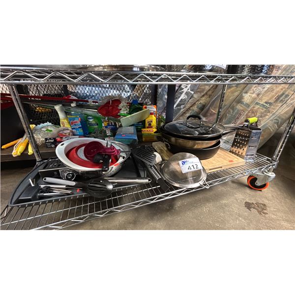 SHELF OF KITCHENWARE: FRYING PANS, CUTTING BOARD, BOX GRATER, STRAINER & MORE