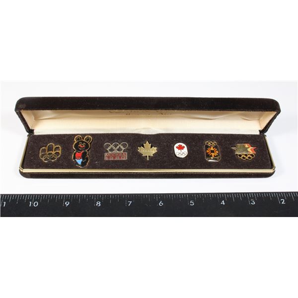 VINTAGE CASE OF 7 OLYMPIC PINS