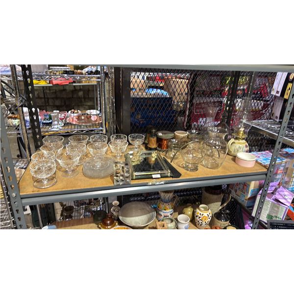 SHELF OF ASSORTED ITEMS INCLUDING; GLASSWARE, OIL LANTERN, HOME DECOR & MORE