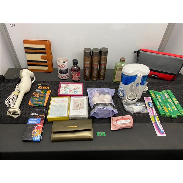 Lot of personal care items including toothbrushes, shampoo, Waterpik brand water flosser and more