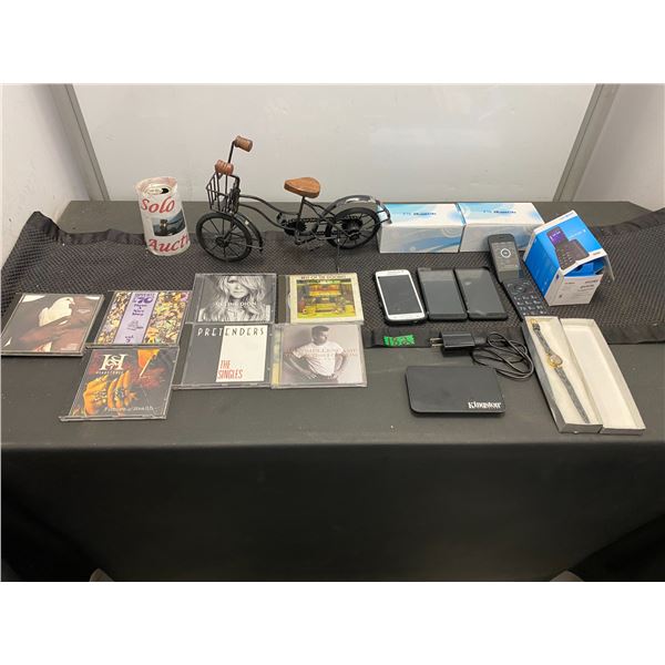 Assorted lot with music CDs, cell phones (not tested) and bicycle ornament