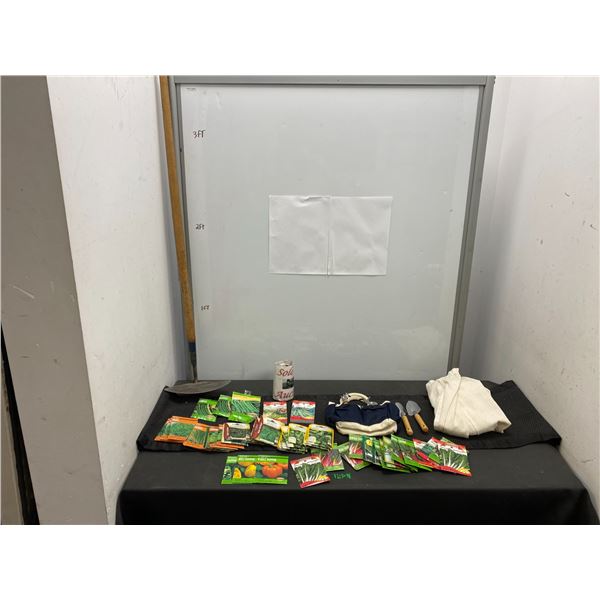 Large assortment of vegetable seed packages and gardening tools