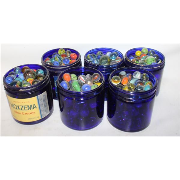 6 VINTAGE MARBLE FILLED BLUE GLASS NOXEMA JARS.