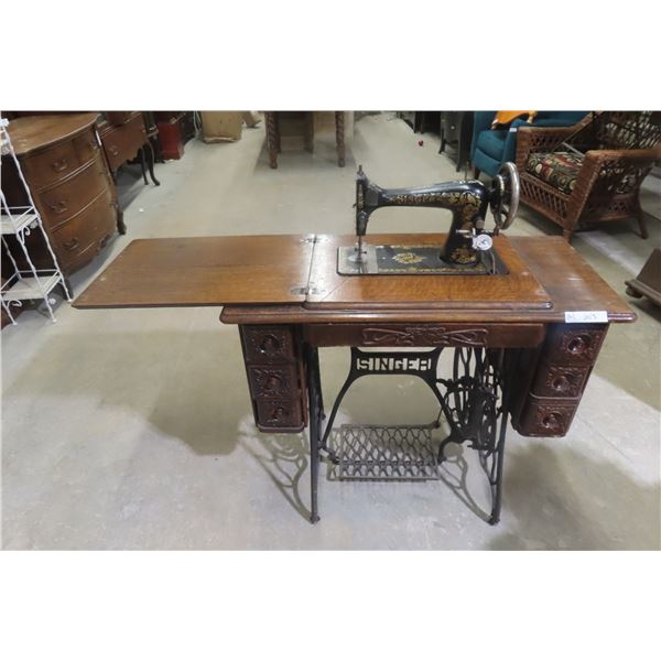Antique Singer Treadle Sewing Machine in Ornate Wooden Cabinet
