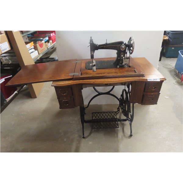 Antique Victorian-Era Treadle Sewing Machine With Ornate Wooden Cabinet