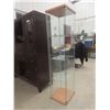 Image 2 : Glass Display Case With Three Glass Shelves Measuring 63 1/2" x 14 1/2" x 16 3/4"