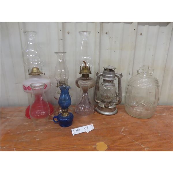 Four Oil Lamps, Lantern, Extra Chimneys, and Glass Jug