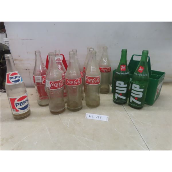 Twelve Soda Bottles With Plastic Carriers Including Coke, 7-Up, and Pepsi