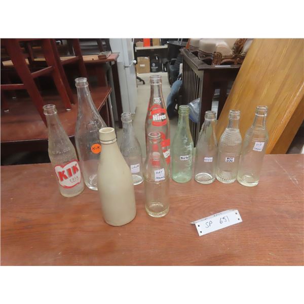 Ten Vintage Soda Bottles Including KIK Cola, Whistle, Pluto, Fort Frances, and More