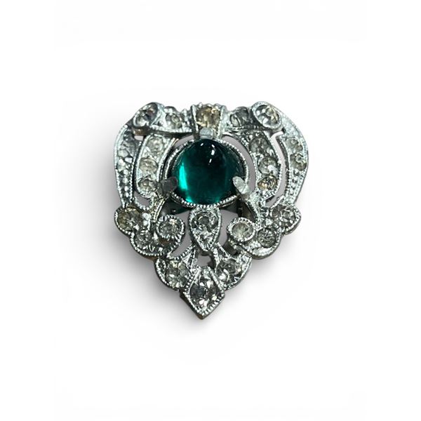 Single vintage silver colored dress clip shield shaped set with colourless and green paste stones.