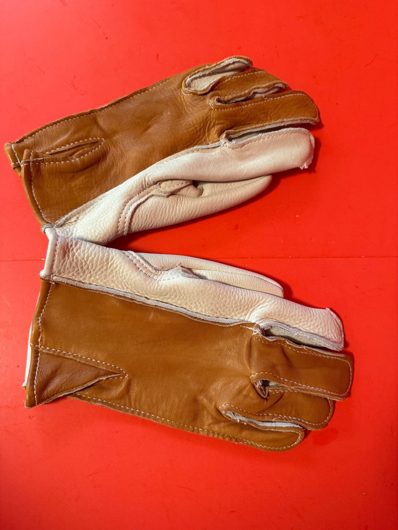 pair of tan leather riding gloves