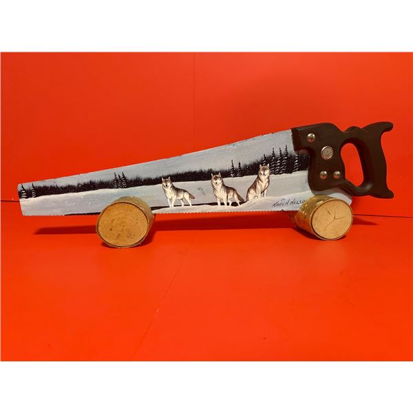 This is a hand-painted saw blade featuring a winter landscape with three wolves, created as a piece