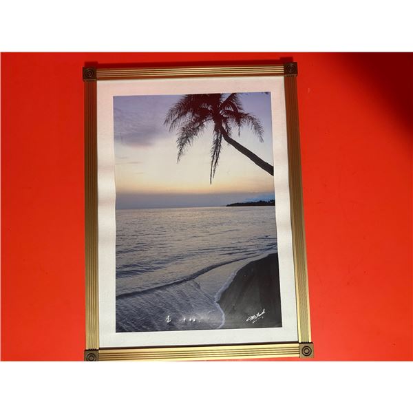 Metal framed photograph of a coastal sunset