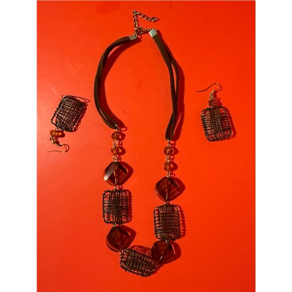 necklace and earring set featuring reddish-brown faceted beads and dark, wire-wrapped square cage-st