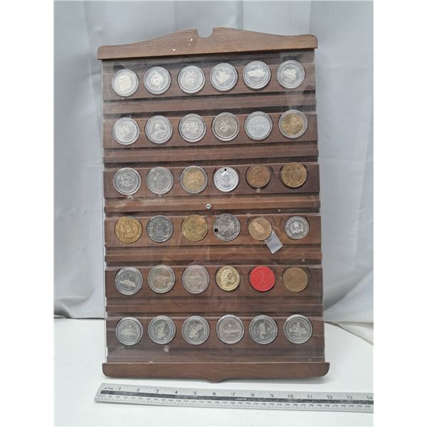 "36 different medals/tokens in a display board"