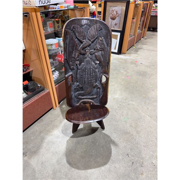 African carved wood tribal chief's or palaver chair with fish and animal carvings.