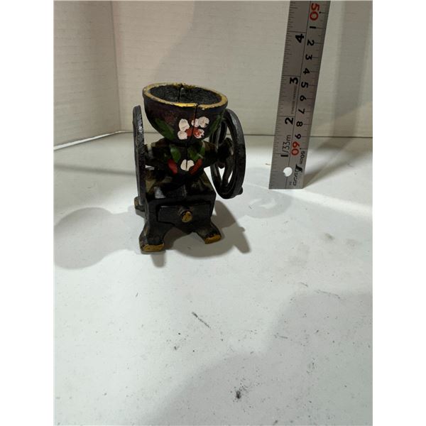 vintage black cast iron miniature coffee grinder with a hand-painted floral pattern.