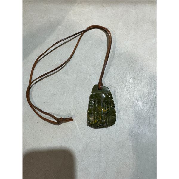 hand-carved nephrite jade Hei Tiki pendant on a leather cord.