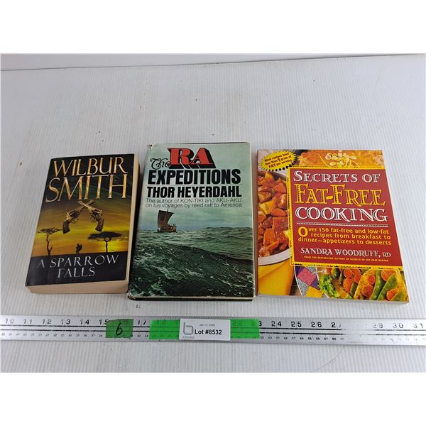 (3) Books - Wilbur Smith, Thor Heyerdahl, Fat Free Cooking by Sandra Woodruff