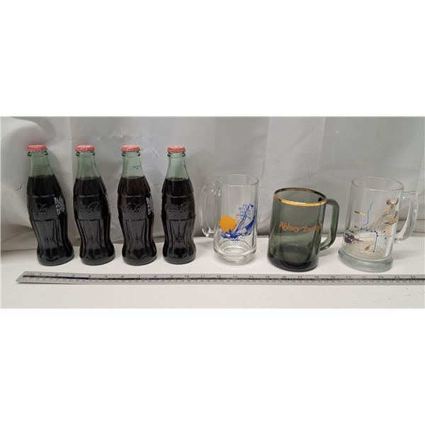 4 sealed coca cola bottles  3 assorted glass cups