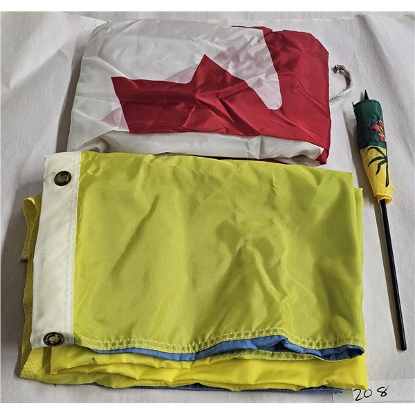 Canadian flag, Ukrainian flag and small Saskatchewan flag, all made of cloth and in good condition.