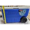Image 1 : Coleman Cooler. Has a drain spout in bottom, two back wheels and handle for towing. Good condition