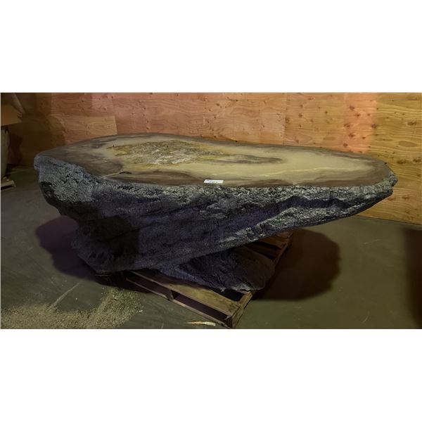 A LARGE TABLE MADE TO LOOK LIKE STONE