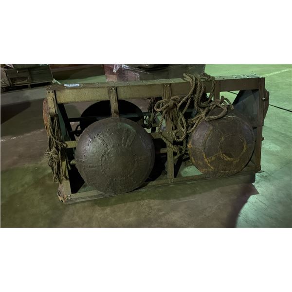 A PRIMITIVE WOK STAND WITH FOUR PRIMITIVE WOKS