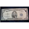 606. Series 1953 $5 U.S. Silver Certificate with hole punch.