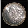 1395. 1904 O Morgan Silver Dollar. Brilliant MS 63 with gold peripheral toning.