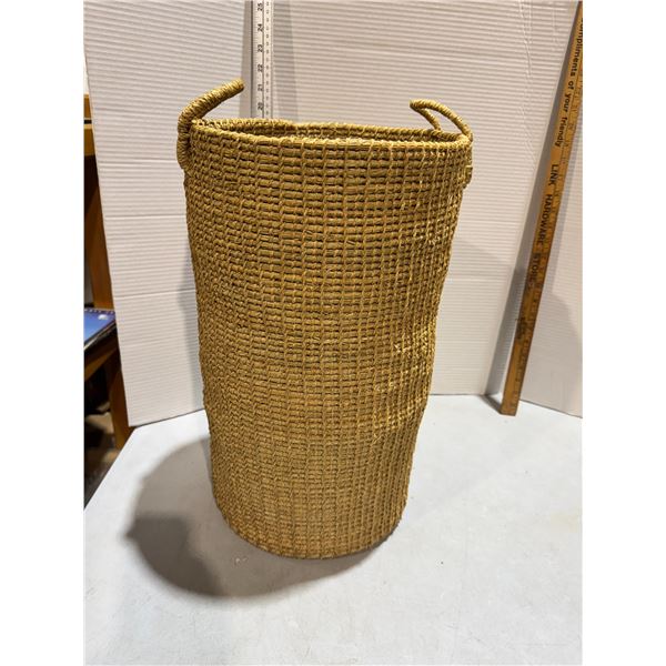 handwoven natural rattan or wicker storage basket with integrated handles.